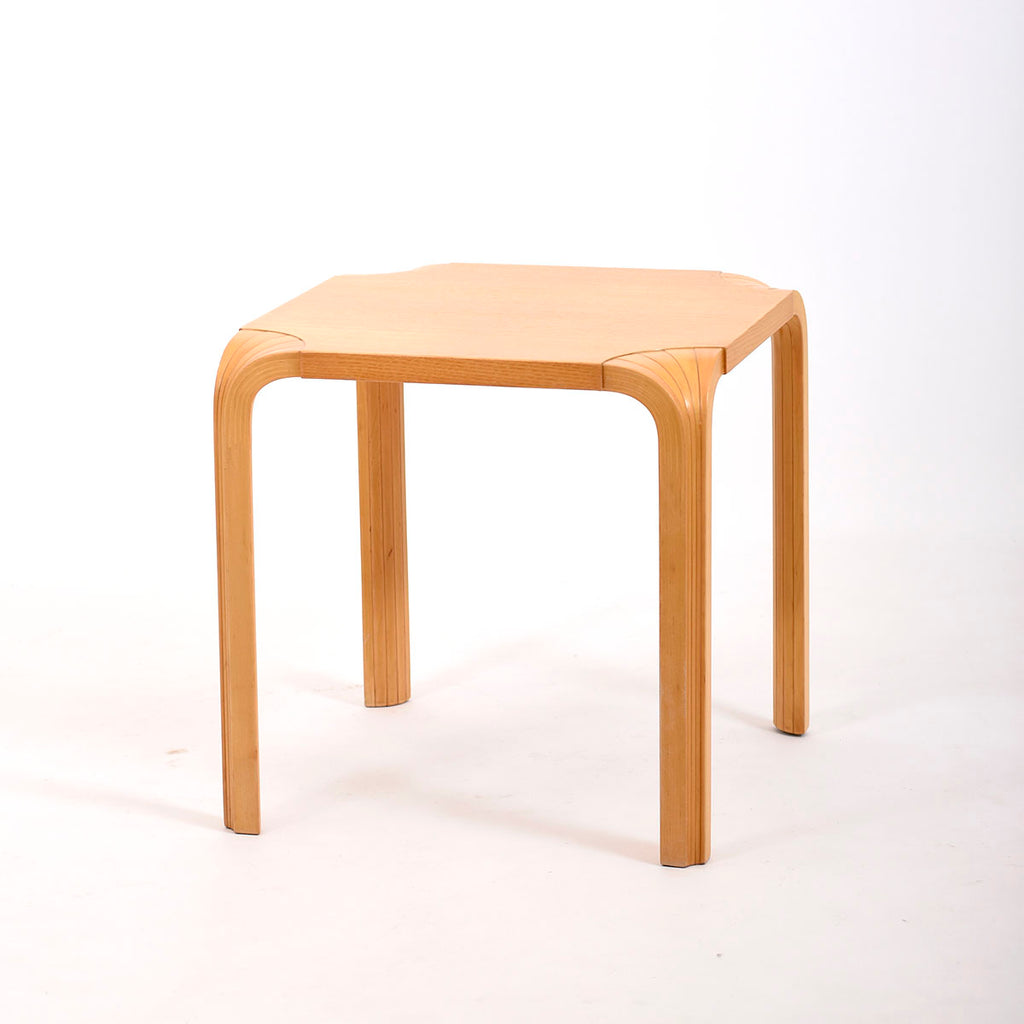 Artek Stool X601, designed by Alvar Aalto in 1954. The stool features a surface made of ash veneer and legs made of solid birch, designed in a fan shape. Dimensions: 45 x 45 x 45 cm. This is a vintage item from the Artek 2nd Cycle collection.