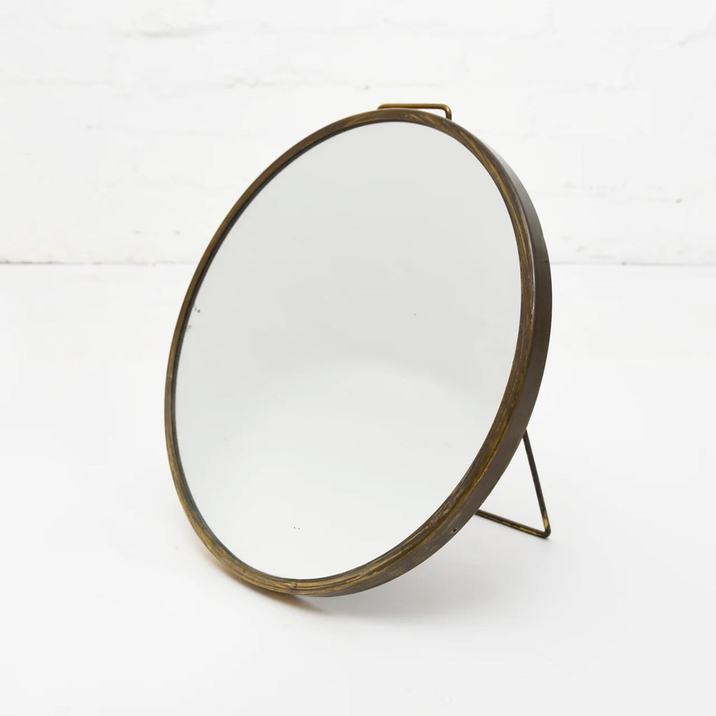 Artek Vanity Table Mirror, designed by Maija Heikinheimo in the 1950s. The mirror features a brass frame and mirror glass, produced by Valaistustyö Ky. The diameter of the mirror is 35.5 cm. This is a vintage item from the Artek 2nd Cycle collection.