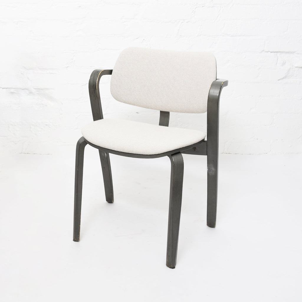 Aslak Chair is available in a gray lacquered frame paired with gray fabric. upholstery. The chair is a vintage piece from the Artek 2nd Cycle collection.