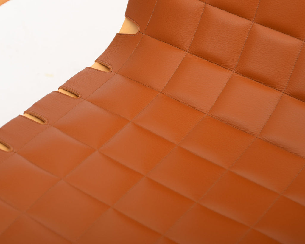 Close-up of the seat upholstery focusing on the craftsmanship of the leather stitching.