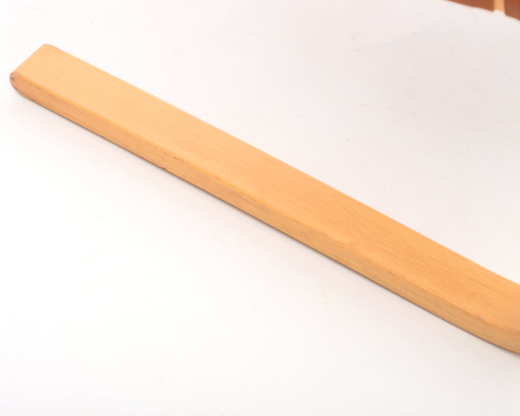 Close-up showing the leg of the armchair.