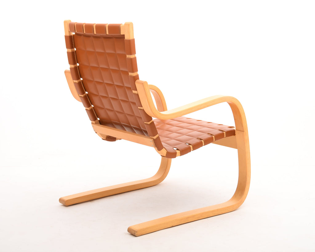 Angled rear view of the full armchair, showing its overall form and design.