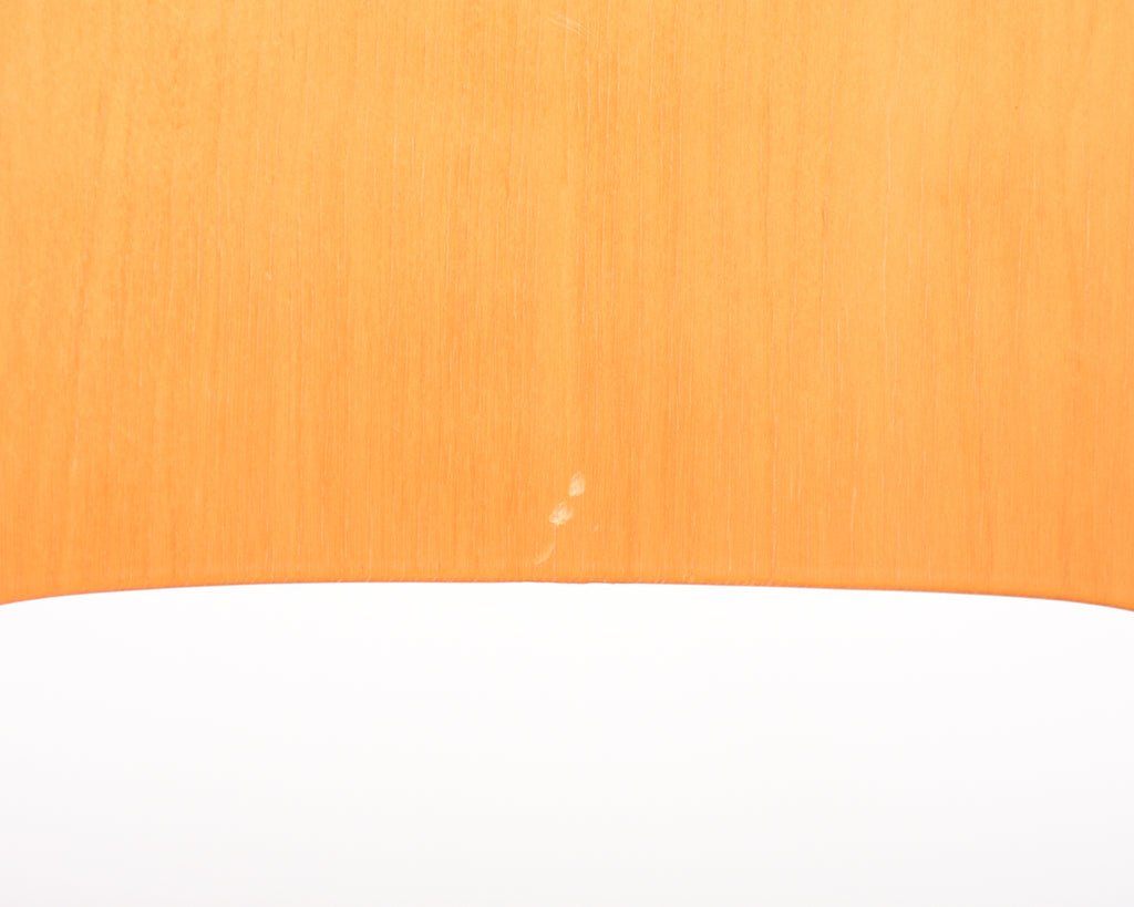 Close-up of a chair backrest showing a small scratch on the surface.