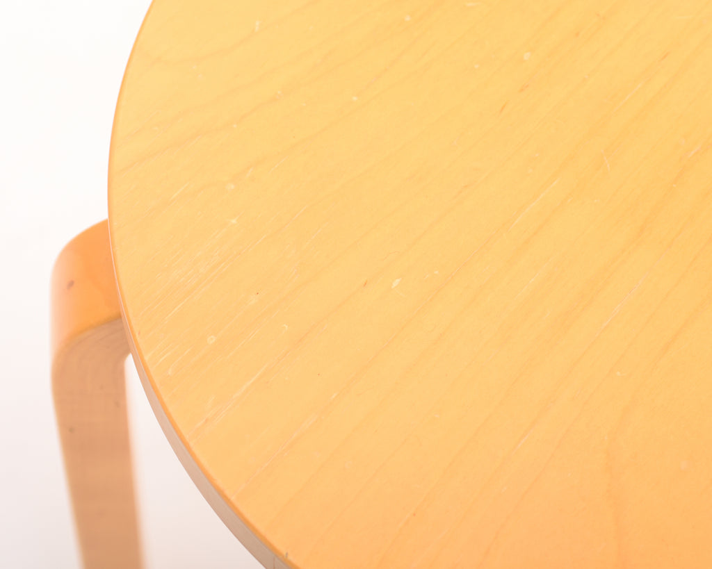 Close-up of a chair seat, with part of one leg visible.