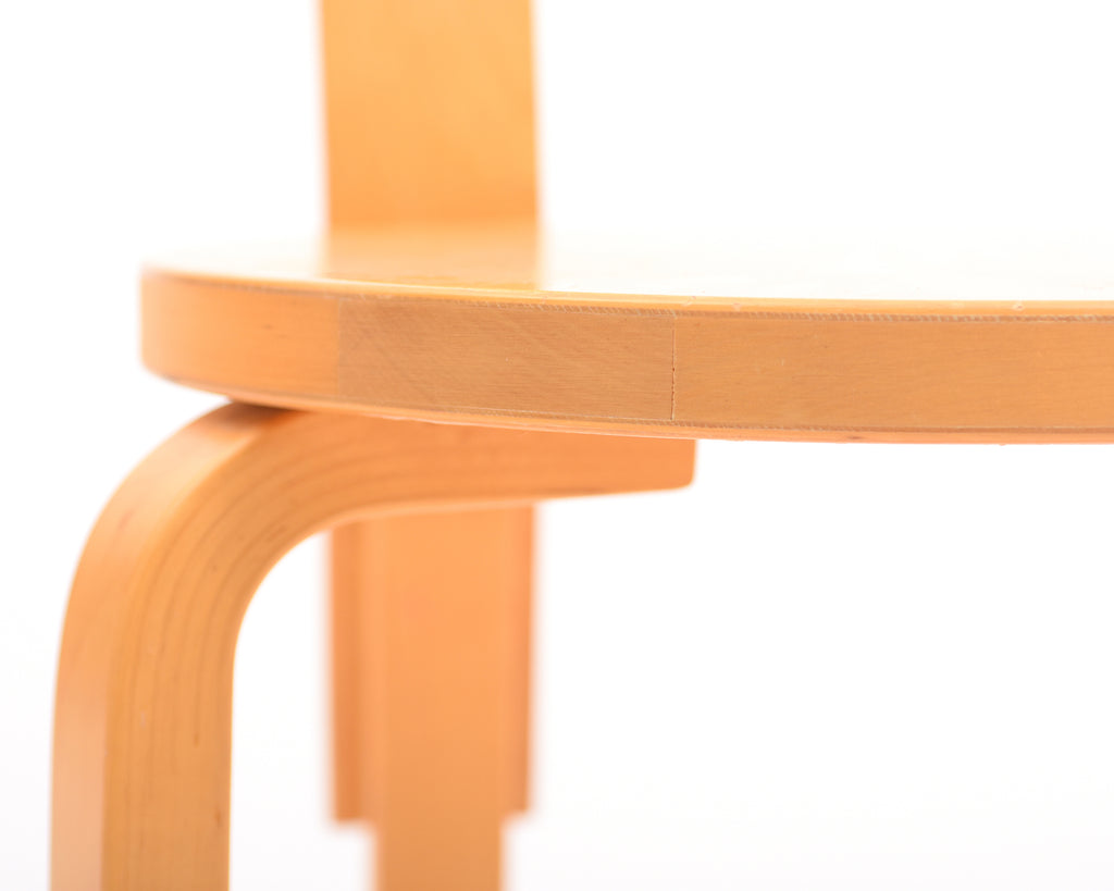 Close-up view of the chair seat showing its thickness and structure, with one front and one back leg visible.