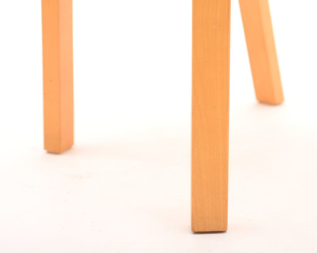 Close-up view of the wooden legs of a chair.