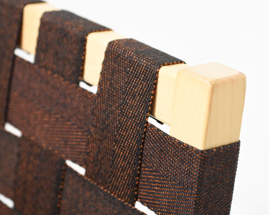 Close-up showing the corner of the backrest with visible brown webbing.