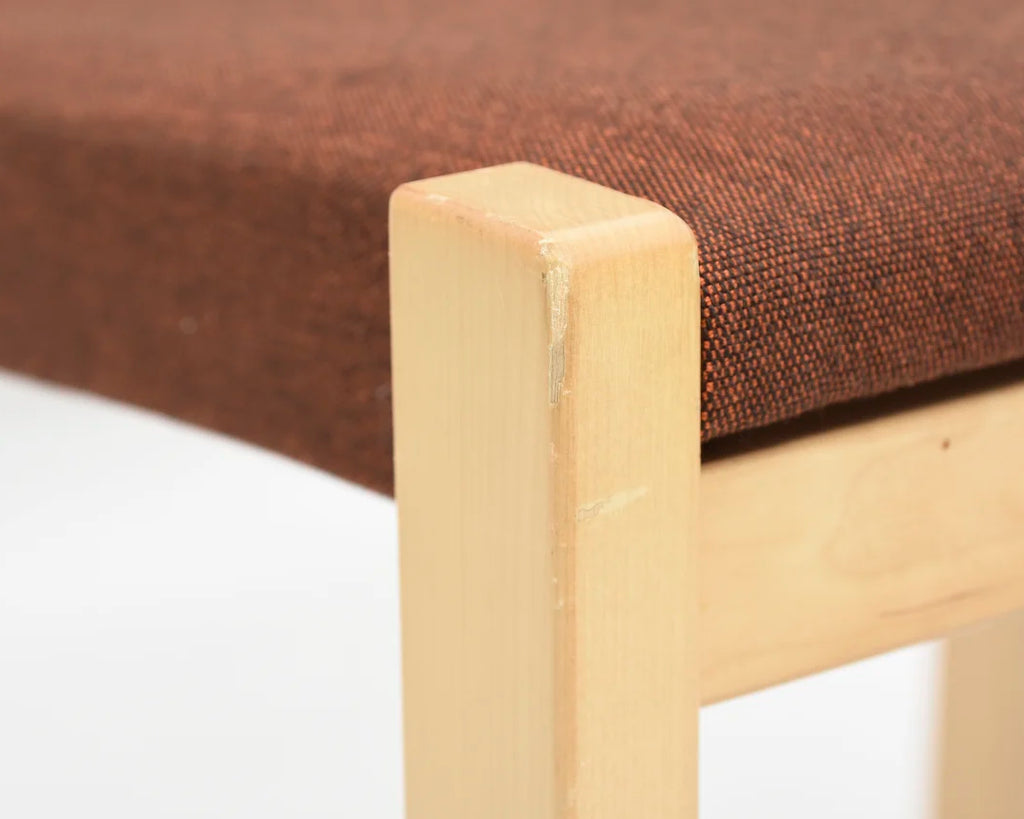 Close-up focusing on the upper part of the chair leg.