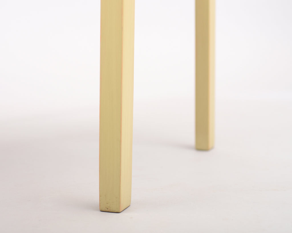 Close-up view of two legs of the Alvar Aalto 611 chair.
