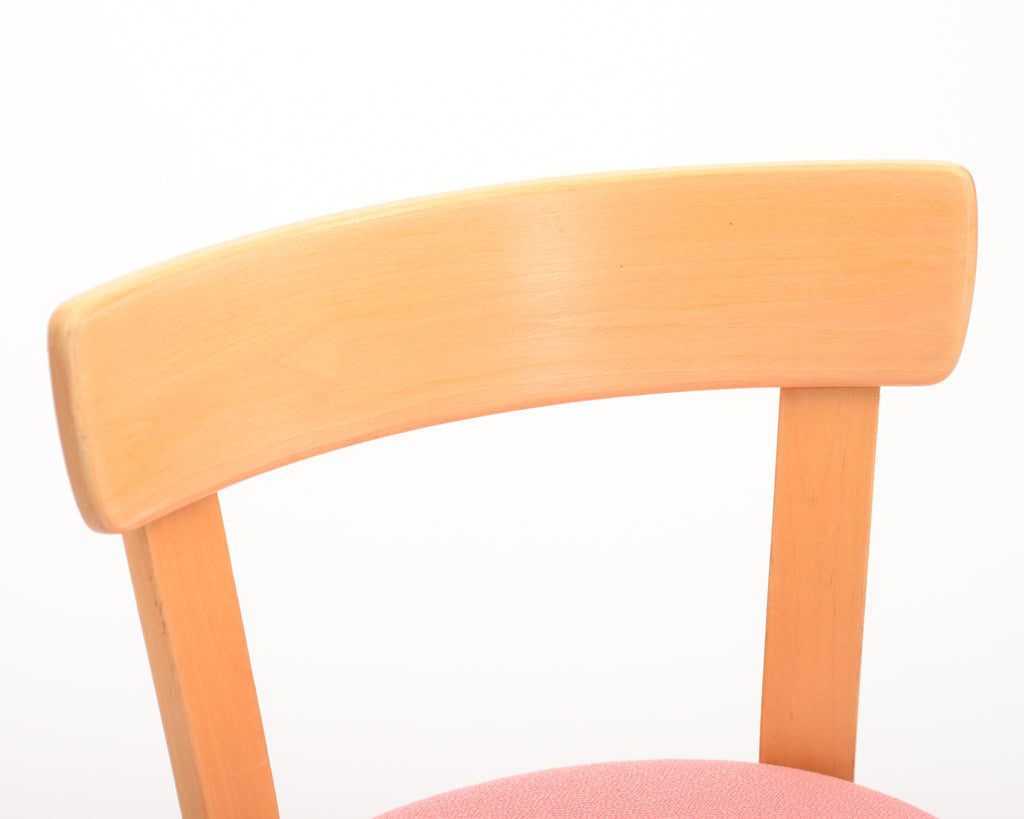 Close-up of a curved birch chair backrest.