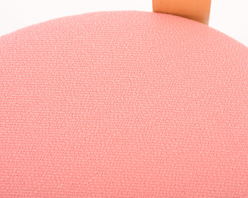 Detailed close-up showing the pink upholstered seat.