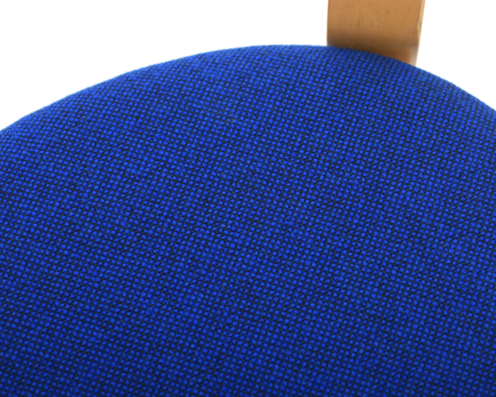 Detailed close-up of the seat showcasing electric blue fabric upholstery.