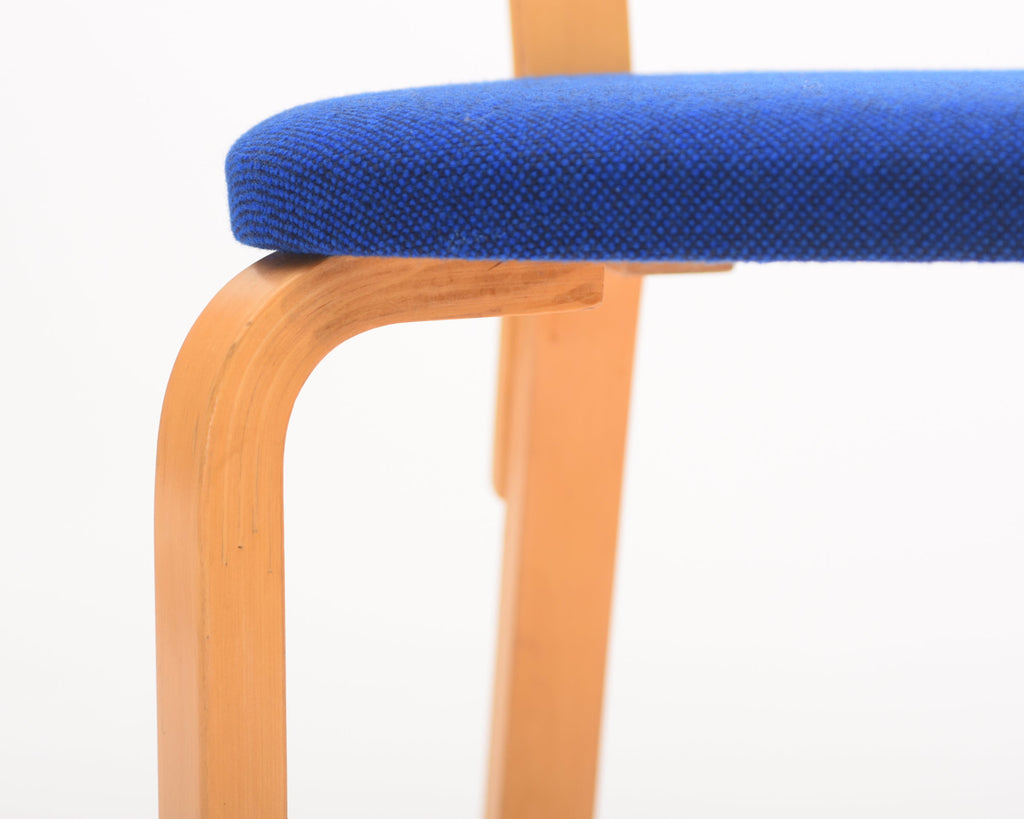Detailed close-up showing the thickness and construction of the blue upholstered seat, with birch legs and backrest visible.