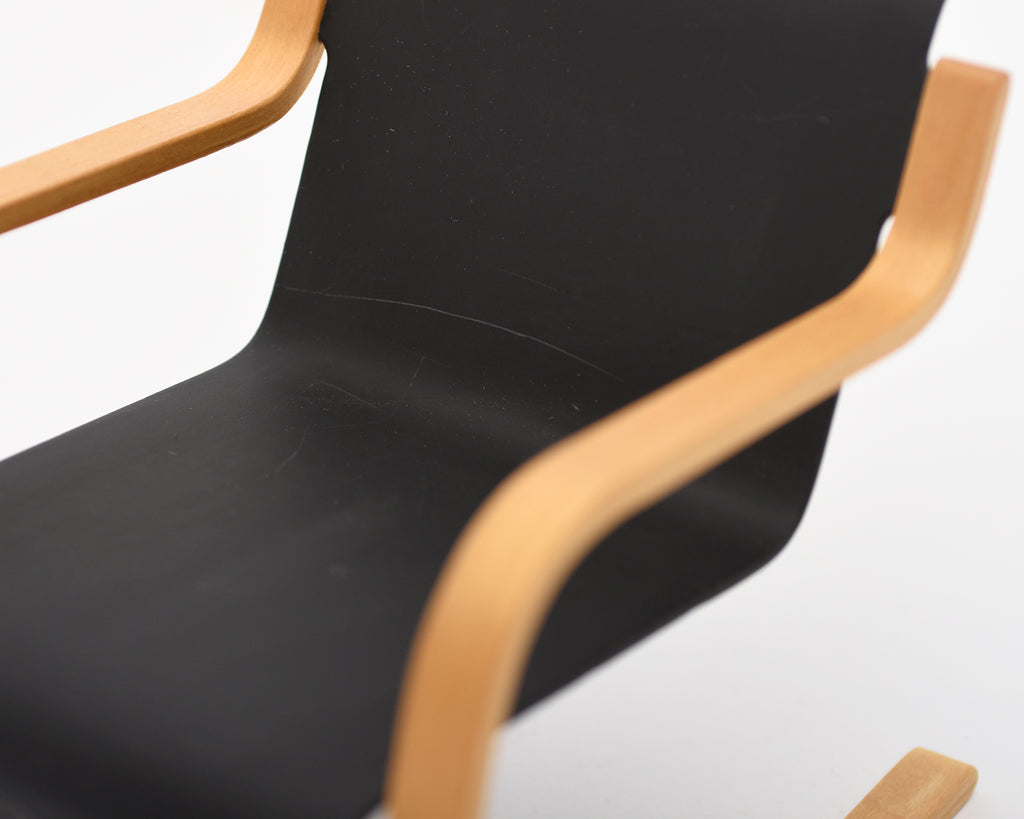 Black chair with wooden armrests on a white background.