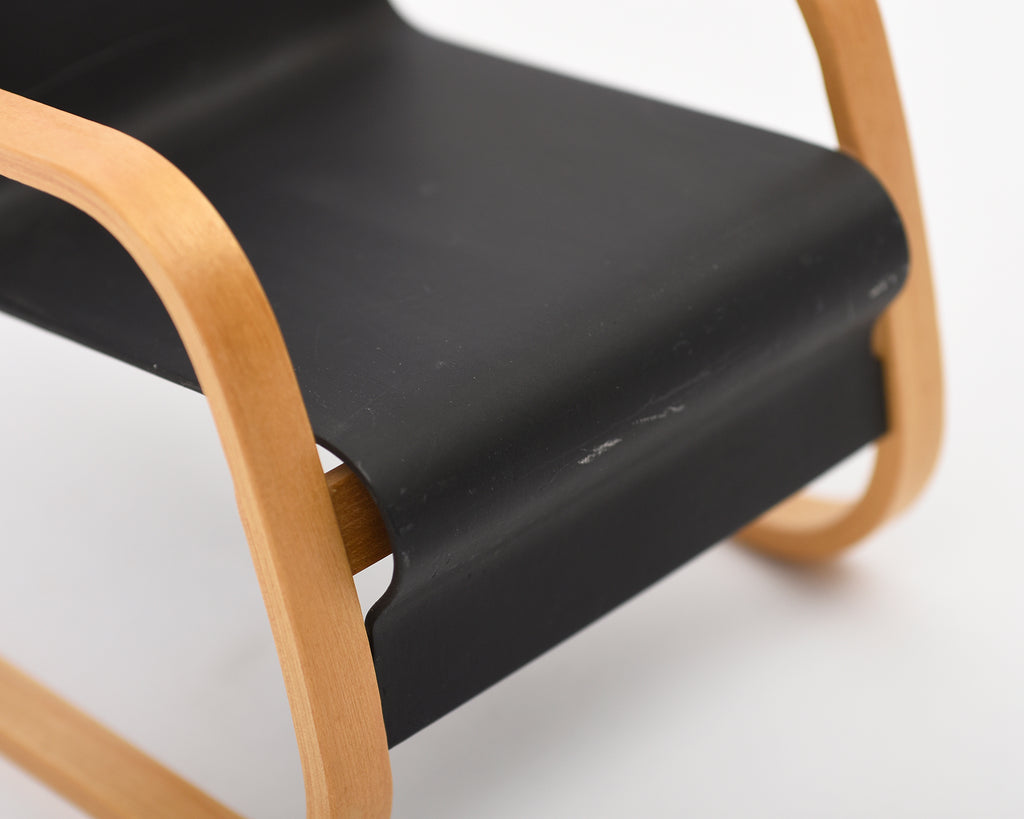 Black chair with wooden frame on a white background.