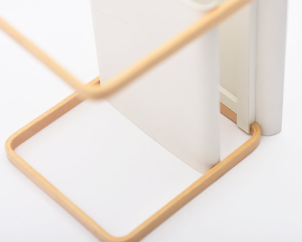 Close-up of a geometric shelf with a wooden frame on a white background.