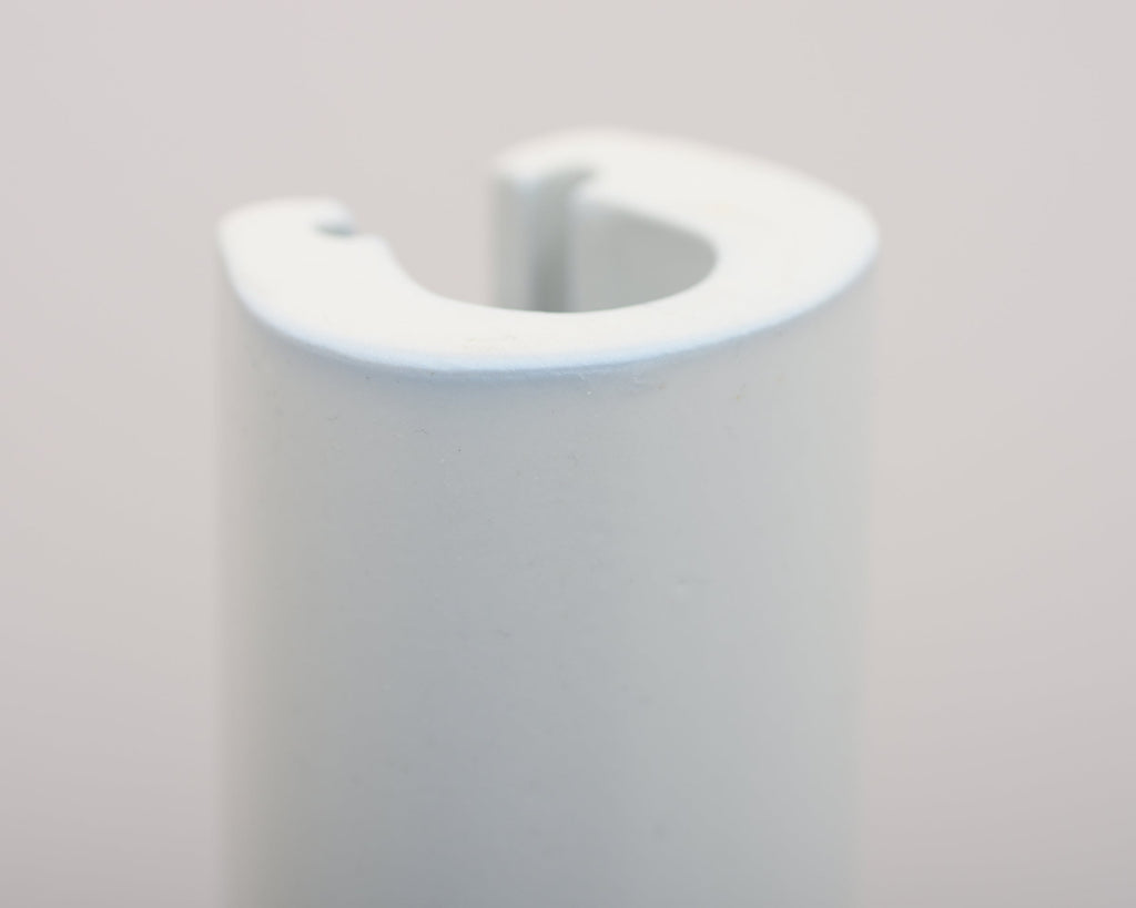 Close-up of the ceramic Aalto Glazed Tile Rod, showcasing its curved design.
