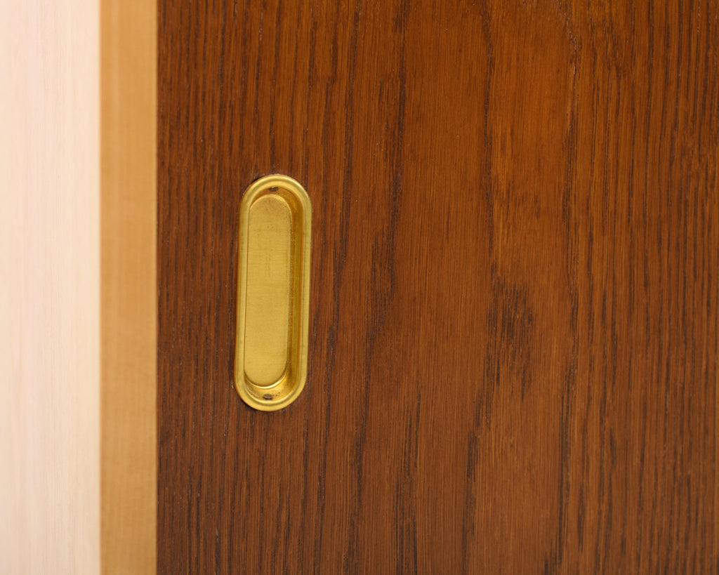 Wooden door with a brass handle.