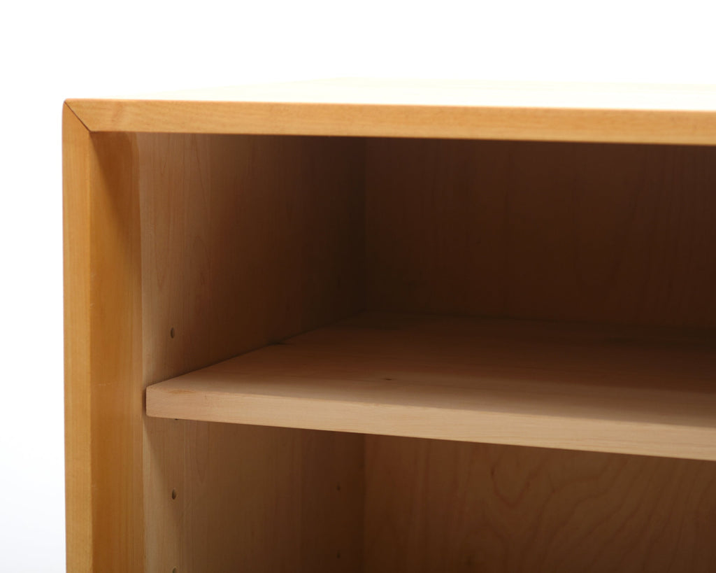 Wooden shelf with a white background.