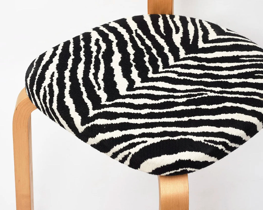 Close-up of the seat of 69 chair upholstered with Zebra fabric.