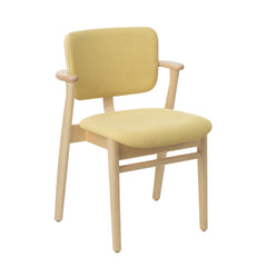 Front view of the Domus Chair in natural‑lacquered birch, upholstered in Hola canary fabric with Prestige cream leather piping.
