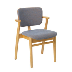 Front view of the Domus Chair in honey‑stained birch, upholstered in Wow Re Blue‑ocre fabric with Prestige nougat leather piping.