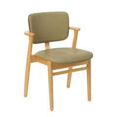 Front view of the Domus Chair in honey‑stained birch, upholstered in Spectrum leaf leather with Spectrum moss leather piping.