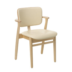 Front view of the Domus Chair in natural‑lacquered birch, upholstered in Prestige cream leather with Prestige Cognac leather piping.