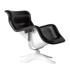 A black and white Karuselli lounge chair with a hard backrest and seat, featuring a design by Yrö Kukkapuro.