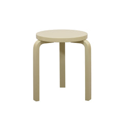 Alvar Aalto’s three‑legged Stool 60 in a straw‑colored finish.