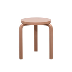 Alvar Aalto’s three‑legged Stool 60 in a glossy terra finish.