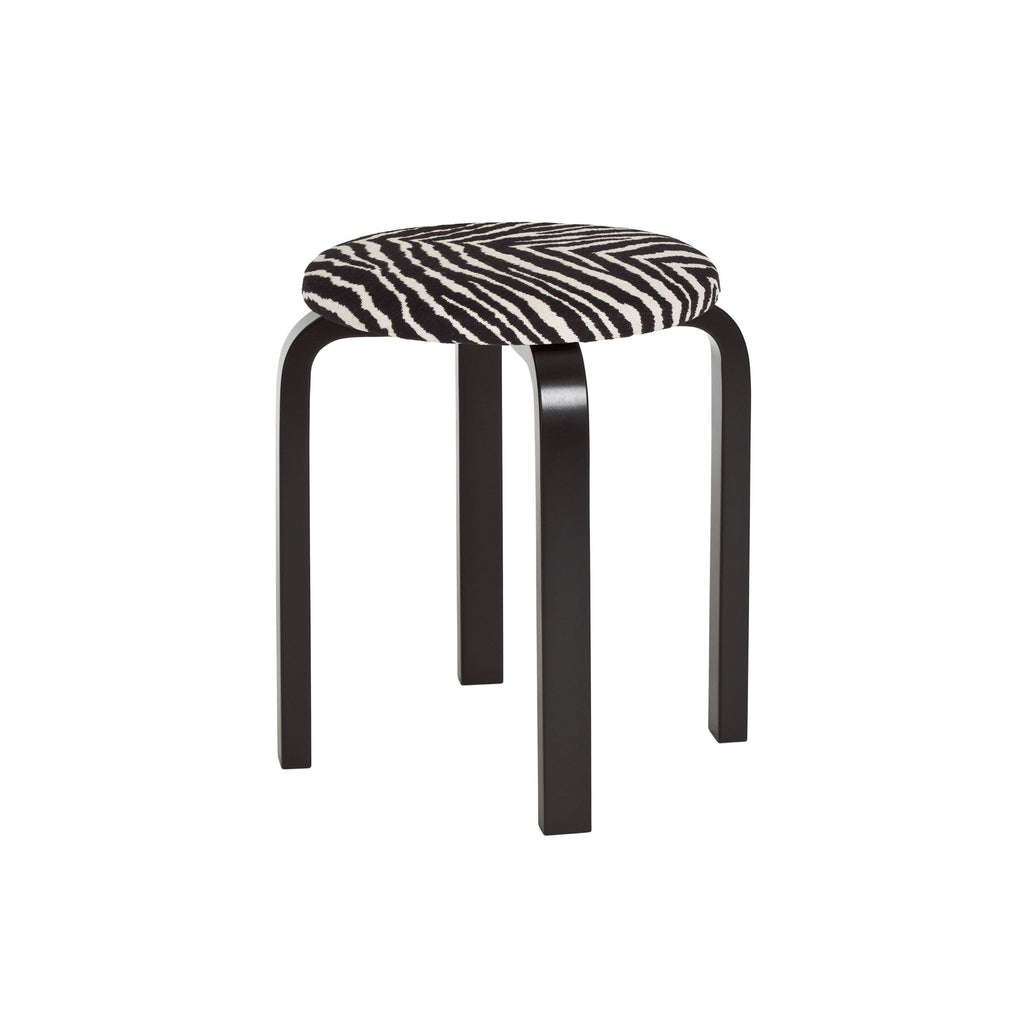 Artek Stool E60, design by Alvar Aalto (four legs): Legs birch black
lacquered, Zebra fabric upholstery with PU foam padding