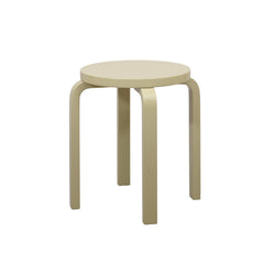Alvar Aalto’s four‑legged E60 Stool in a straw‑colored finish.