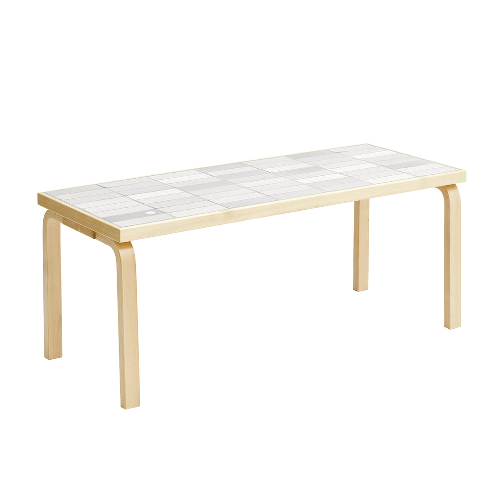 Artek + Heath Tile Table rectangular featuring a white‑toned ceramic tile surface and birch legs, measuring 109 x 44 x 44 centimeters.