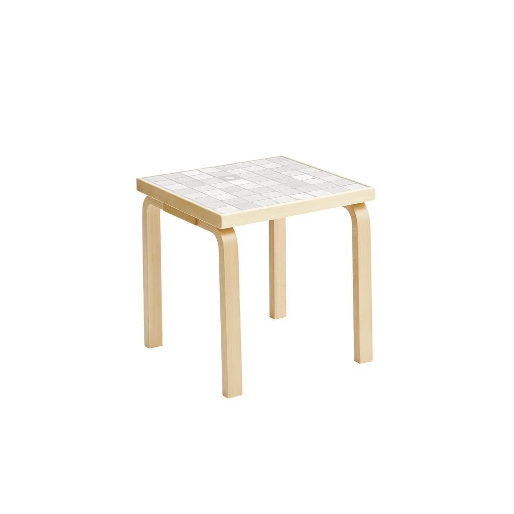 Artek + Heath Tile Table Square featuring a white‑toned ceramic tile surface and birch legs, measuring 44 x 44 x 44 centimeters.