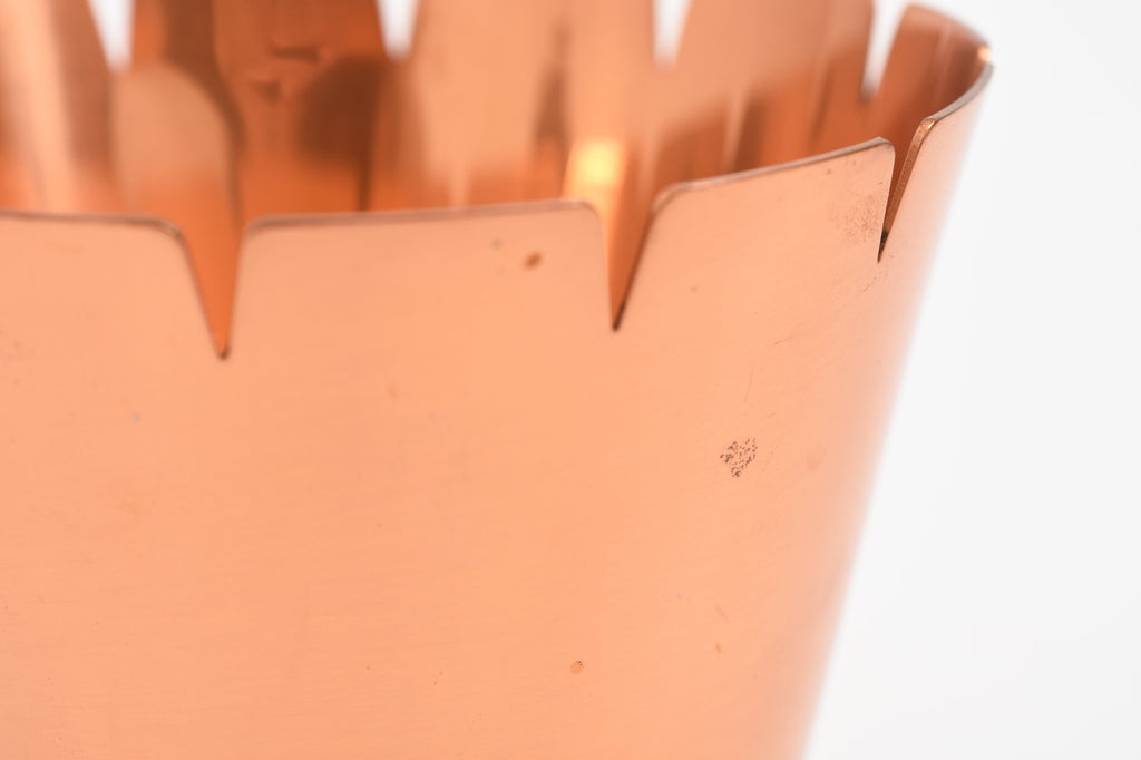 Close-up of a copper vase on a white background.