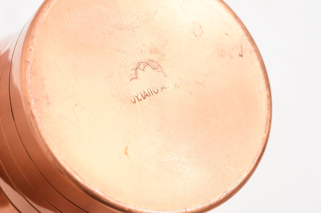 Close-up taken from the bottom of a copper vase, showing the marking ‘oy. taito ab.