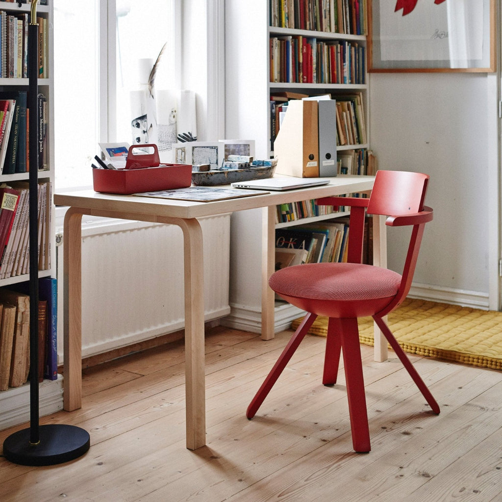 Interior view of a workspace featuring Aalto Table 80A paired with a red Rival Chair.