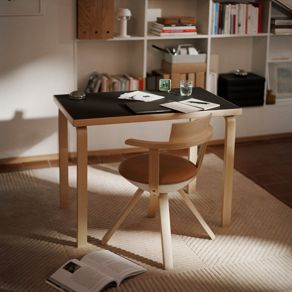 Interior view of a workspace featuring Aalto Table 80B with a black linoleum top paired with Rival Chair.