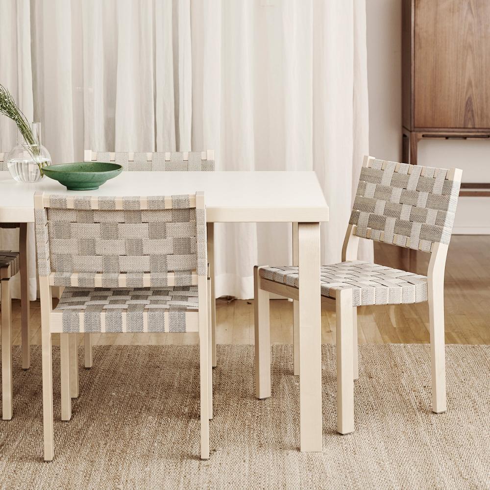 Close-up interior view of a dining area featuring Aalto Table 83, surrounded by Chair 611.