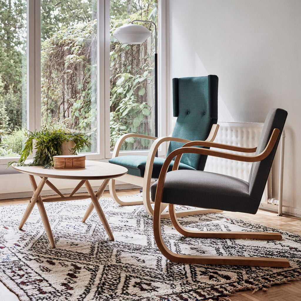 Interior view of a living room featuring Armchair 401 and Armchair 402 placed around an oak Ovalette Table.