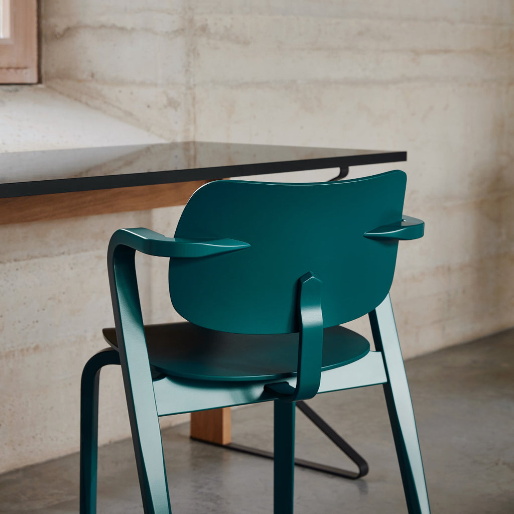 Close‑up interior view of a petrol‑coloured Aslak Chair photographed from the back. Kaari Desk is positioned above the chair.