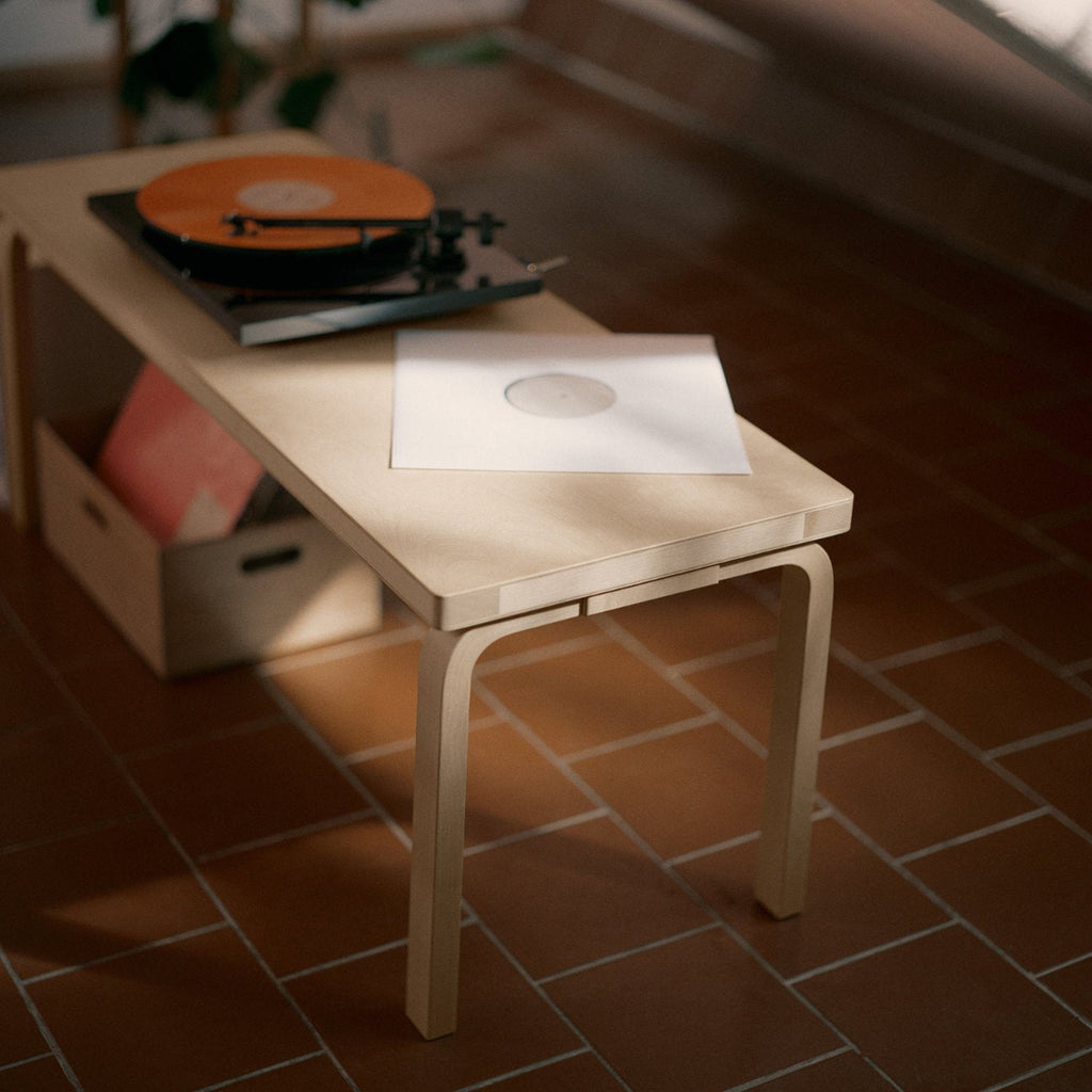 Interior view featuring a full birch Bench 153A with a solid top. A turntable and a vinyl record are placed on the bench.