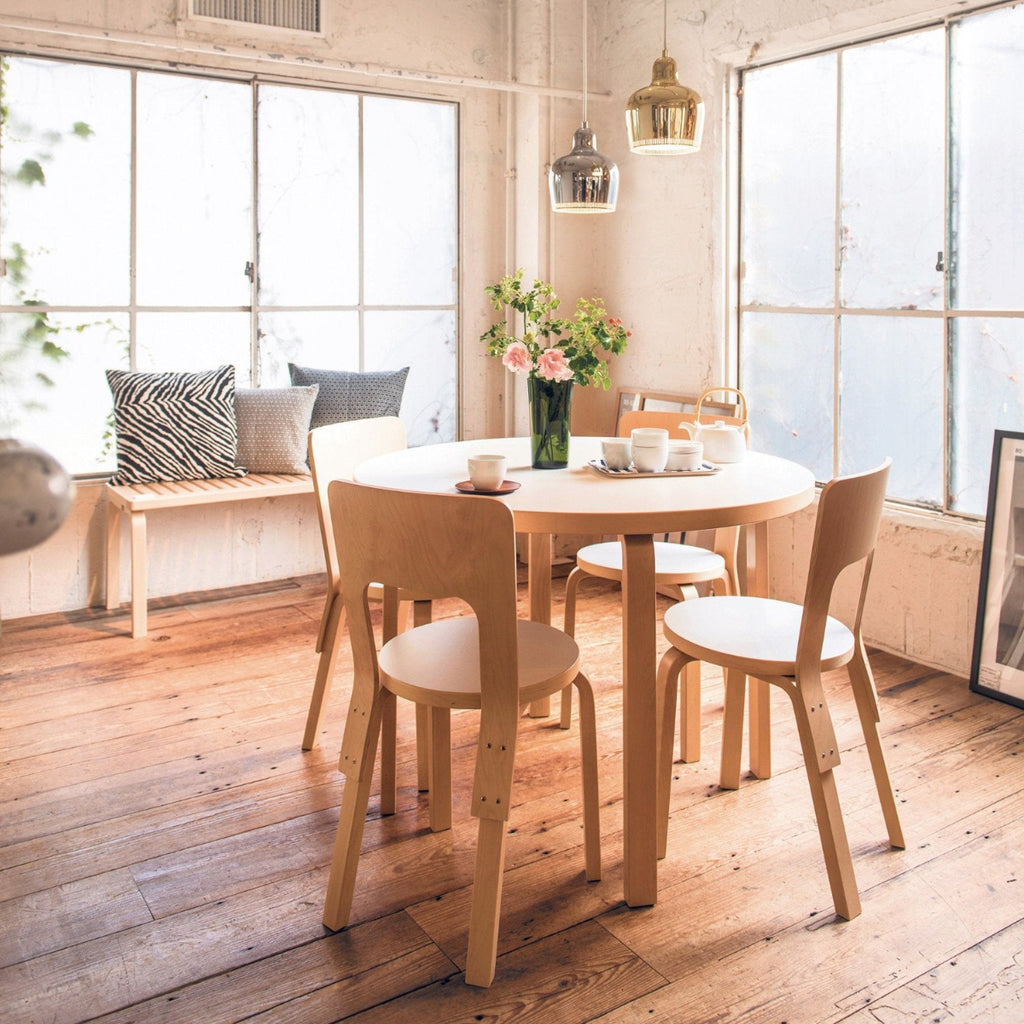 A dining space with an Aalto Table 90A surrounded by Chair 66. Above the table hang two A330S pendant lights.