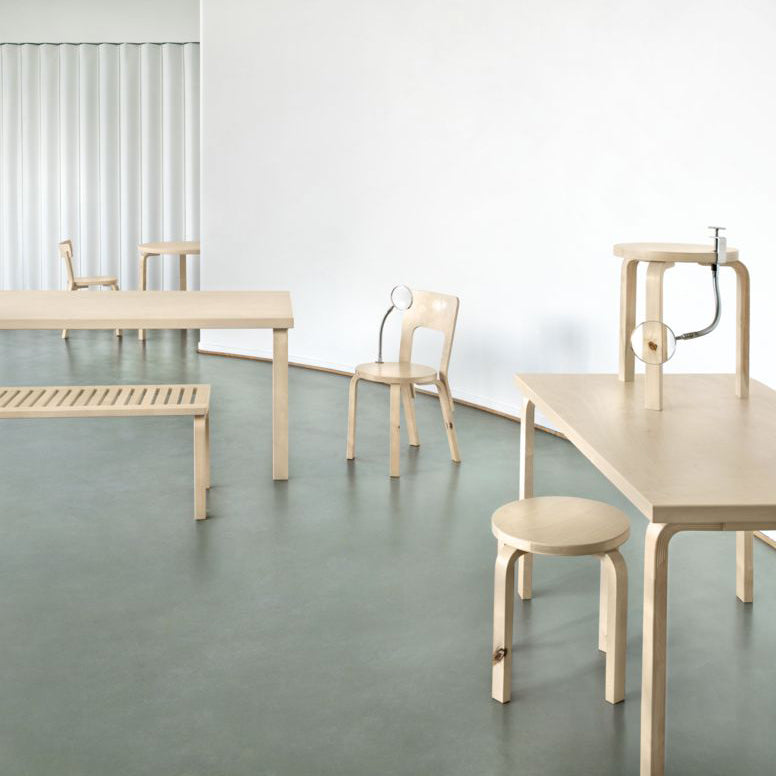 Interior view of a minimalist space with a green-toned floor and white walls, featuring products from the Forest Collection.