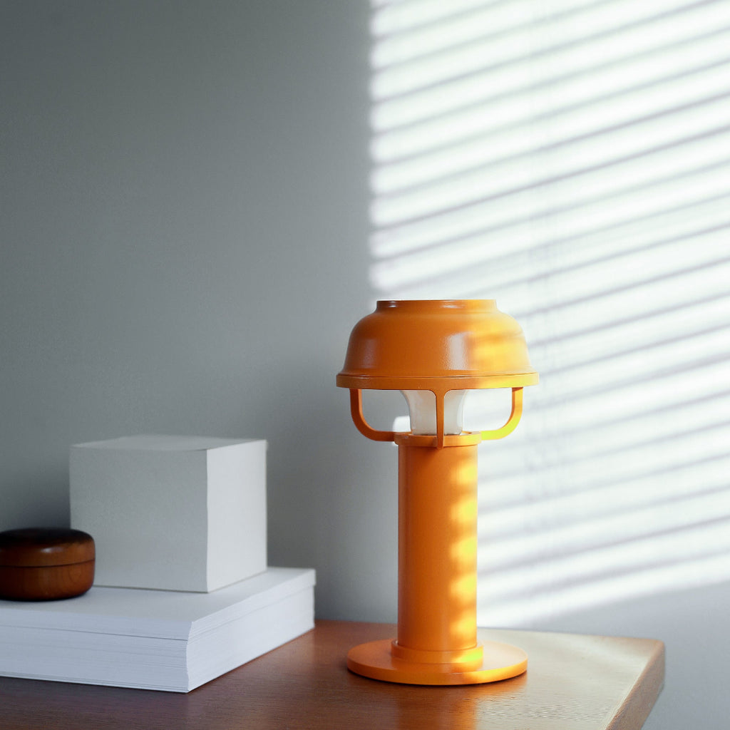 Interior view featuring orange Kori Table Light switched off, placed on a bedside table in daylight.