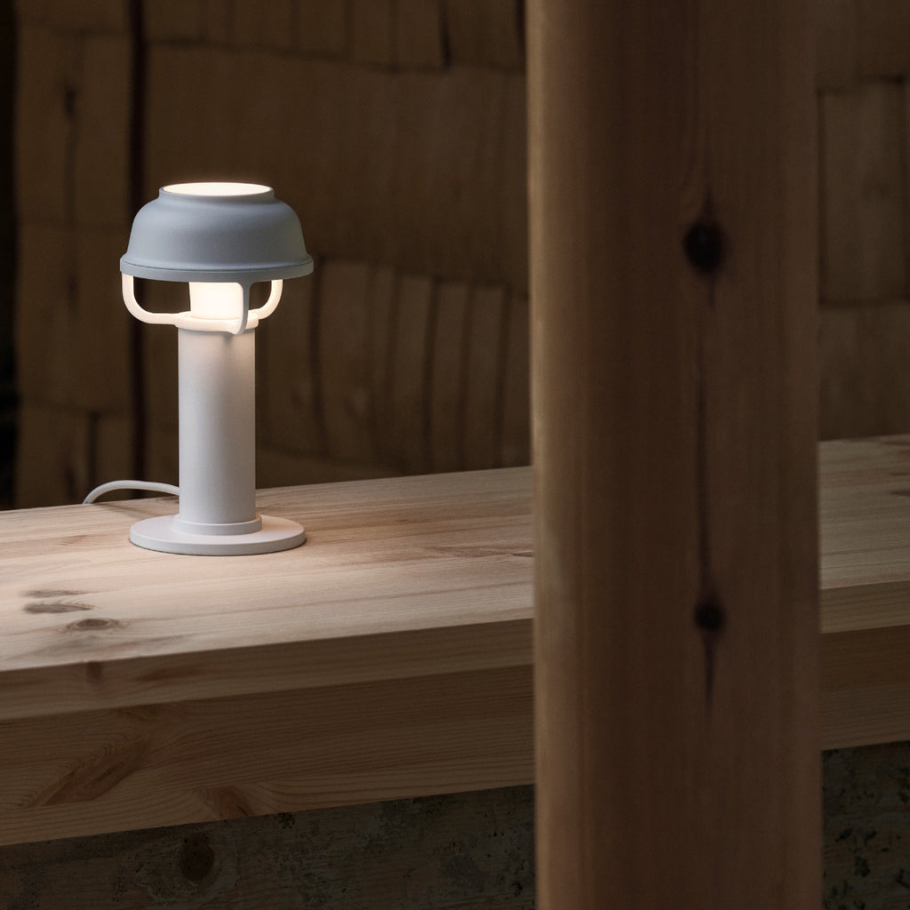Interior view featuring white Kori Table Light switched on, placed on a table.