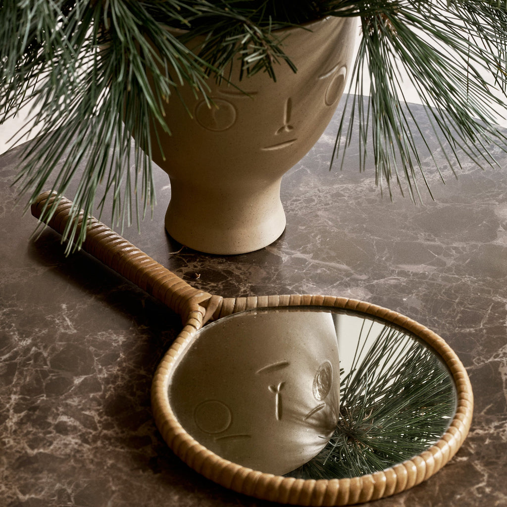 
Close-up interior view featuring Midsummer Dream Vase placed on a marble table with fir branches inside. A small hand mirror is also positioned on the table.