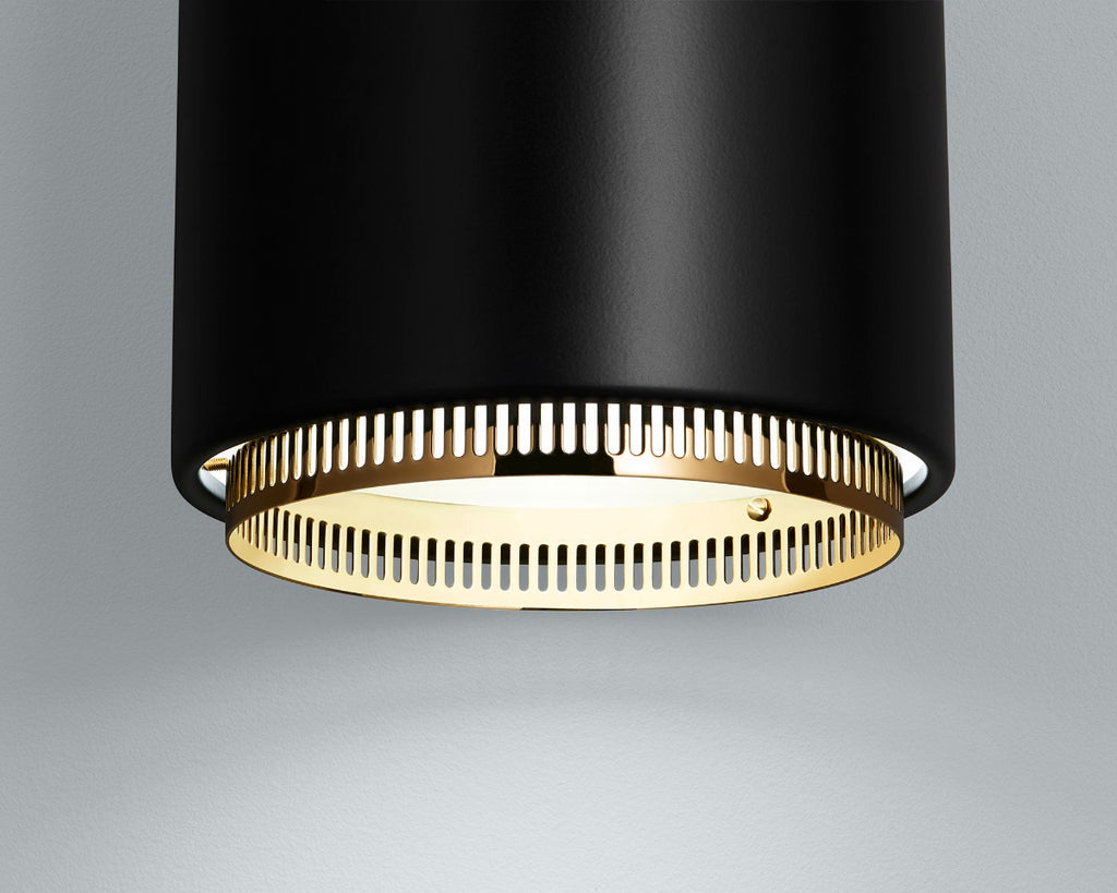 Close-up product image of black Artek Pendant Light A110, focusing on the lower section of the fixture with a visible brass ring detail.