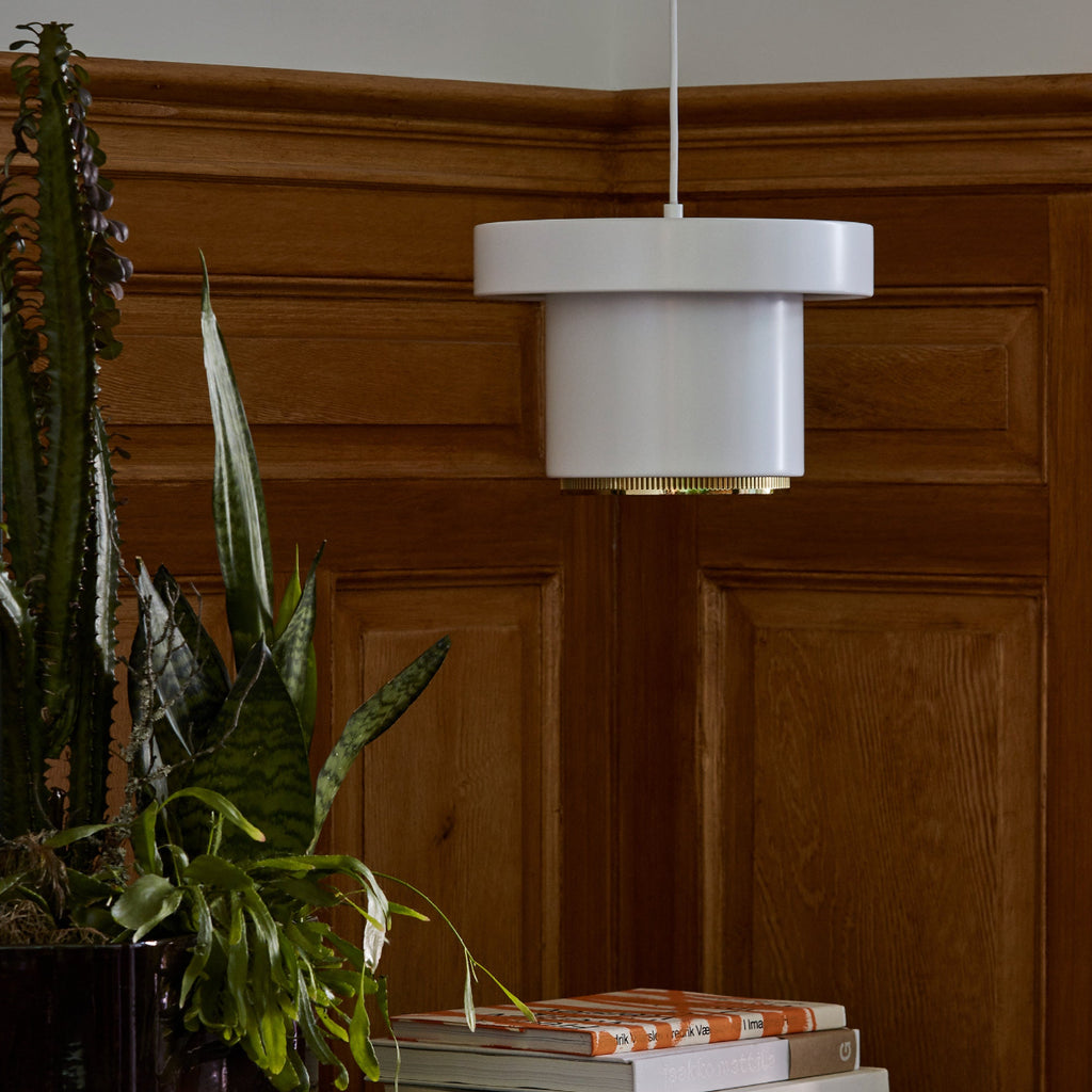 Interior view of a hallway lit by daylight, featuring a Pendant Light A201 placed on a side table. The light is switched off.